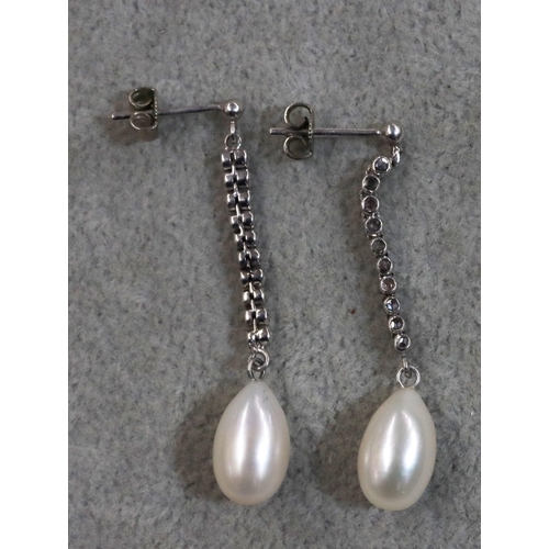 752 - A pair of white gold cultured pearl drop earrings, each set with a line of 10 rough cut diamonds, 4.... 