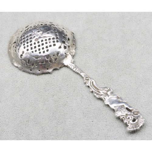 299 - A Continental silver coloured metal sifter spoon with cupid handle having raised pierced figure, flo... 