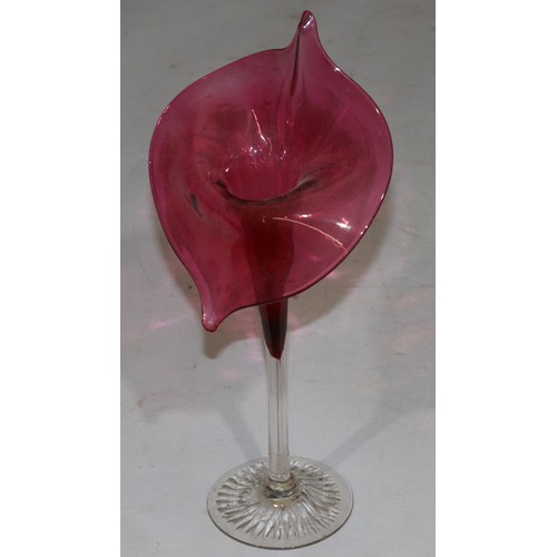 179 - A Victorian ruby and clear glass vase in form of a trumpet shaped flower 32cm high