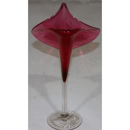 179 - A Victorian ruby and clear glass vase in form of a trumpet shaped flower 32cm high