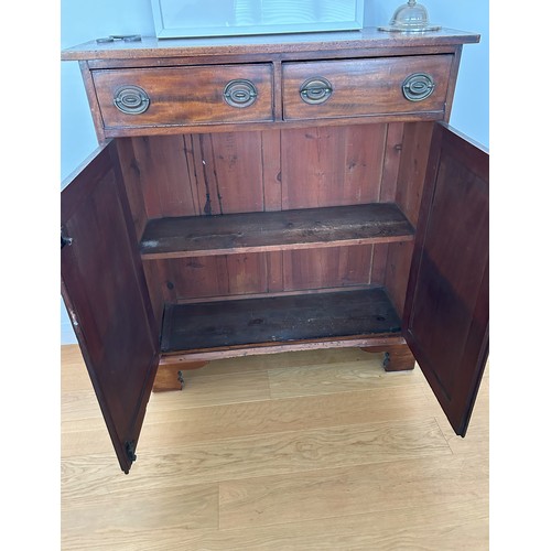 1412 - A 19th Century mahogany side cabinet with 2 drawers, brass pull handles and 2 panel doors enclosing ... 