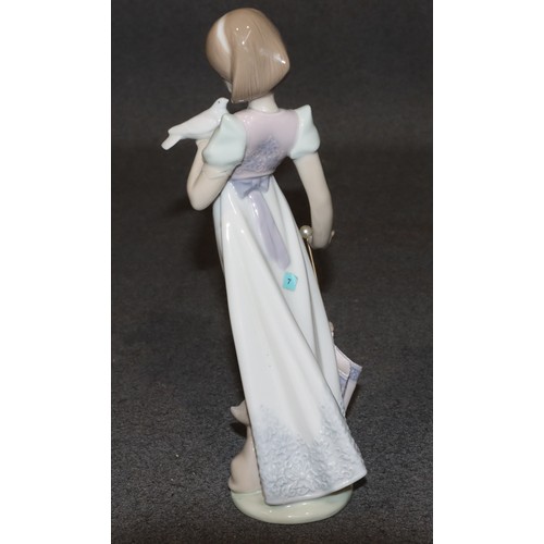 180 - A Lladro figure of a young standing lady, holding a dove with cat and closed parasol at her feet, 22... 