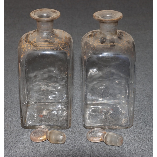 78 - A pair of 19th Century small square glass thin necked decanters with stoppers, gilt decoration (gilt... 