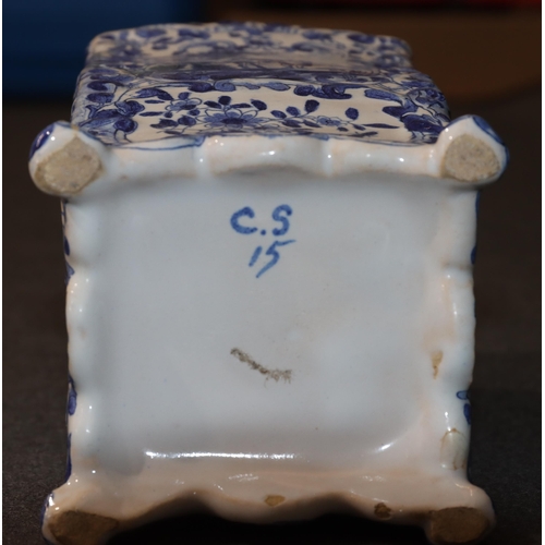 83 - A Continental Delft blue and white ornament in the form of a Sedan chair with allover floral, leaf a... 