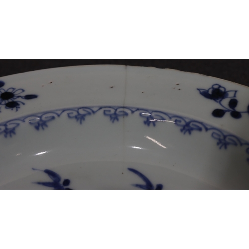 101 - An 18th Century Chinese plate with river landscape decoration on blue and white ground, 23.2cm diame... 