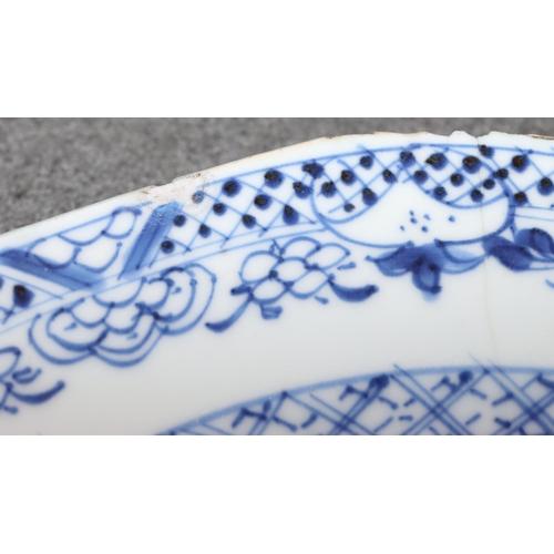 101 - An 18th Century Chinese plate with river landscape decoration on blue and white ground, 23.2cm diame... 