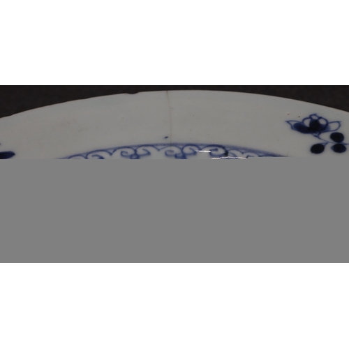 101 - An 18th Century Chinese plate with river landscape decoration on blue and white ground, 23.2cm diame... 