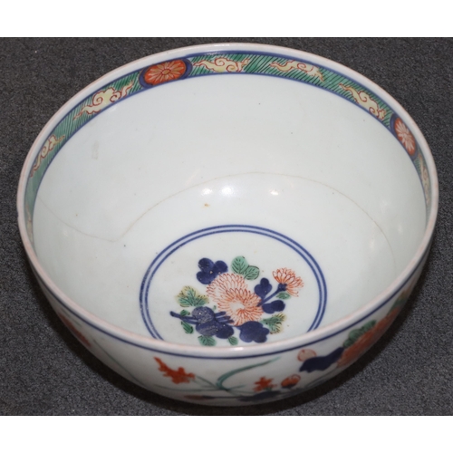 168 - An Imari round bowl on white ground with red, blue and green floral, leaf and gilt decoration (crack... 