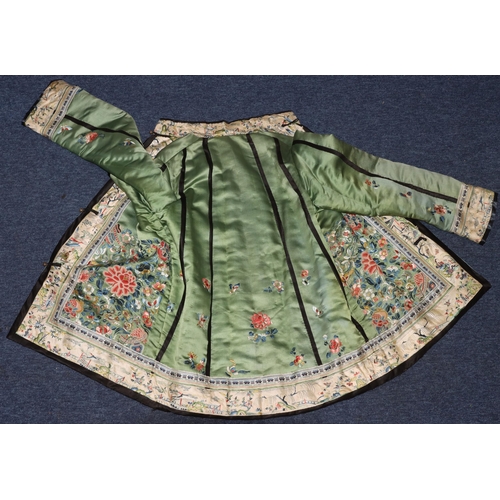 927 - A Chinese ladies' green silk short jacket with Mandarin collar, finely hand embroidered with allover... 