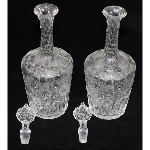 23 - A pair of cut glass round bulbous thin necked decanters with thumb pattern decoration and stoppers, ... 