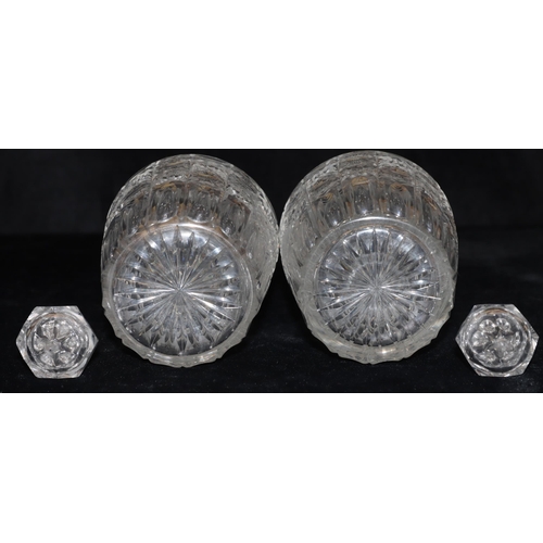 23 - A pair of cut glass round bulbous thin necked decanters with thumb pattern decoration and stoppers, ... 