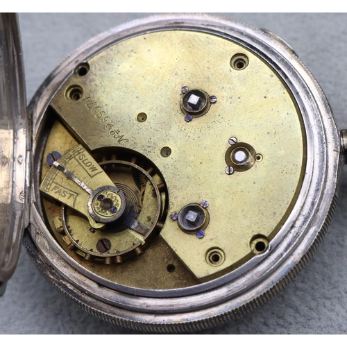 613 - A Chester silver pocket watch with white enamel dial and Roman and Arabic numerals, with locking but... 