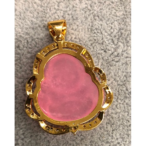 1266 - A pink hardstone Buddha shaped pendant, 4.2cm long.