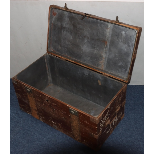 984 - A rectangular wood trunk with metal bandings and corners, large carrying handles, hinged lid enclosi... 