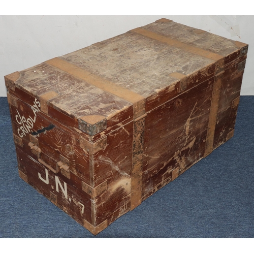 984 - A rectangular wood trunk with metal bandings and corners, large carrying handles, hinged lid enclosi... 