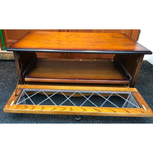 2008 - A TV cabinet with hinged glass front panel enclosing a slide out shelf, 78cm wide, 48cm deep, 36cm h... 