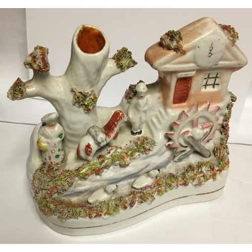 2325 - A 19th Century Staffordshire spill vase in the form of figures outside watermill, 12cm high.