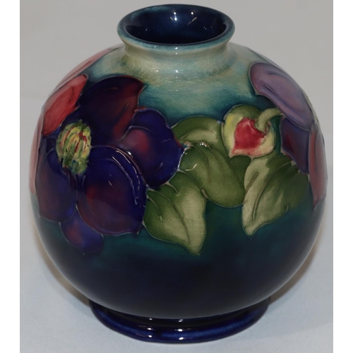 101 - A Moorcroft round bulbous thin necked vase on blue and pale green ground with multi-coloured floral ... 