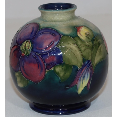 101 - A Moorcroft round bulbous thin necked vase on blue and pale green ground with multi-coloured floral ... 