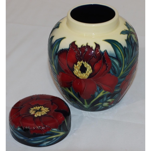 102 - A modern Moorcroft round bulbous thin necked ginger jar with cover on yellow, red and blue ground wi... 