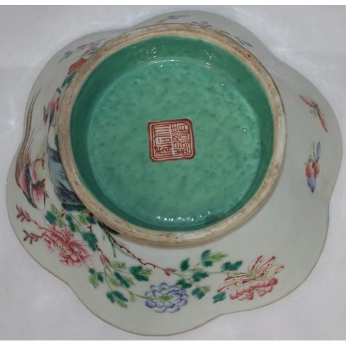 109 - An Oriental round scallop shaped bowl on white and pale green ground with multi-coloured bird, branc... 