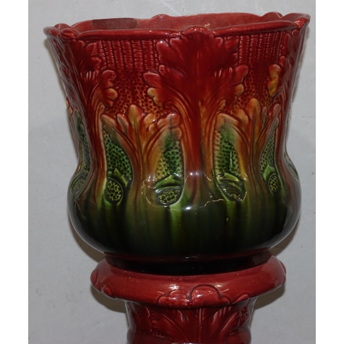 112 - A Bretby style round bulbous trumpet shaped jardiniere on stand, on green and red ground with raised... 