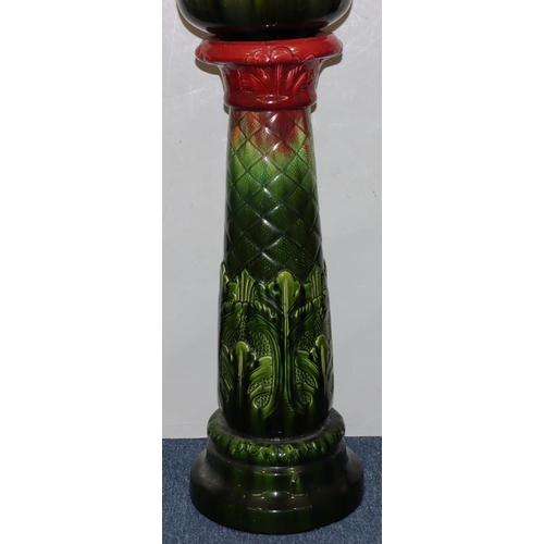 112 - A Bretby style round bulbous trumpet shaped jardiniere on stand, on green and red ground with raised... 