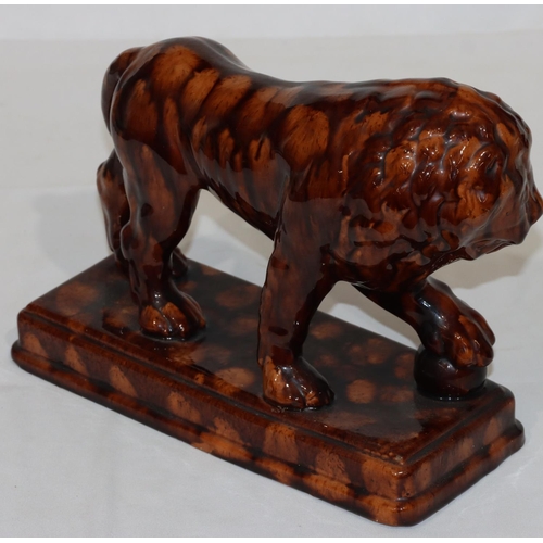 114 - A Treacle Ware style model of a lion on rectangular shaped base, 31cm long, 22cm high