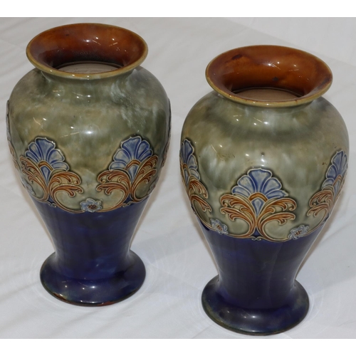 115 - A pair of Royal Doulton glazed earthenware round bulbous thin necked trumpet shaped vases on green a... 