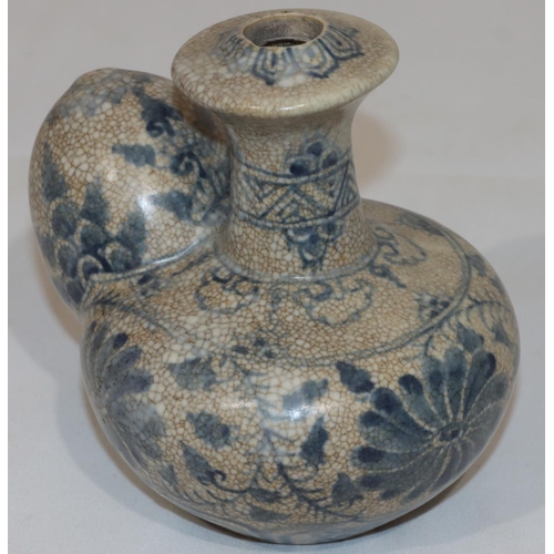 124 - An Anamese pot on white and blue ground with floral and leaf decoration, 12.5cm high