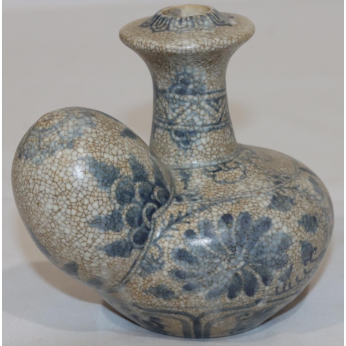 124 - An Anamese pot on white and blue ground with floral and leaf decoration, 12.5cm high