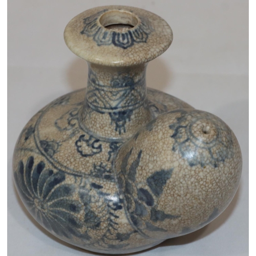 124 - An Anamese pot on white and blue ground with floral and leaf decoration, 12.5cm high