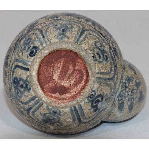 124 - An Anamese pot on white and blue ground with floral and leaf decoration, 12.5cm high