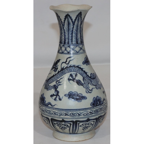 125 - A blue and white Chinese round bulbous thin necked trumpet shaped vase with dragon decoration, 27.5c... 