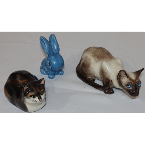 132 - Winstanley Pottery figure of a cat with blue glass eyes, 26.5cm long, another china figure of a cat ... 