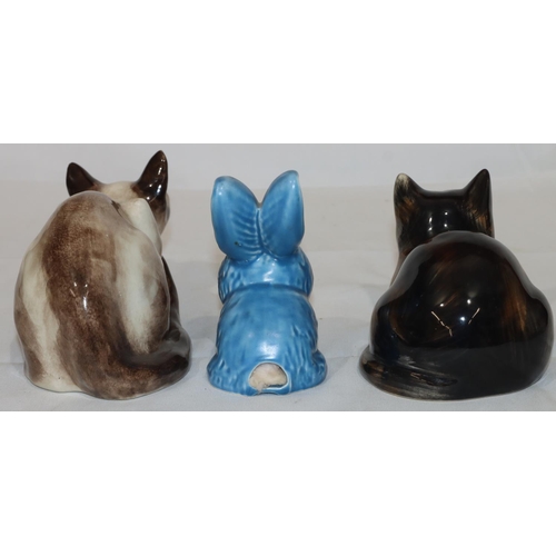 132 - Winstanley Pottery figure of a cat with blue glass eyes, 26.5cm long, another china figure of a cat ... 