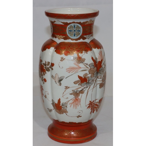 136 - A Kutani round bulbous thin necked trumpet shaped vase on white and red ground with multi-coloured b... 