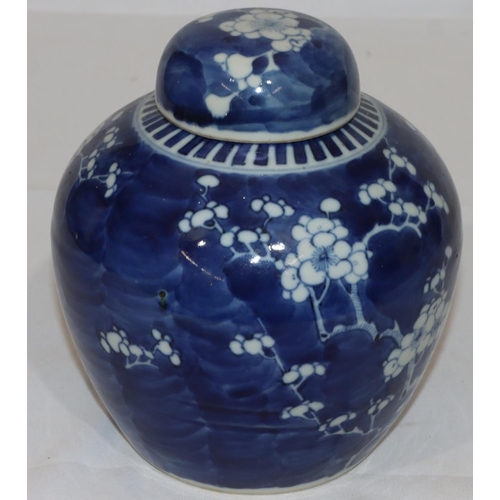 137 - An Oriental blue and white round bulbous shaped lidded ginger jar with blossom and branch decoration... 