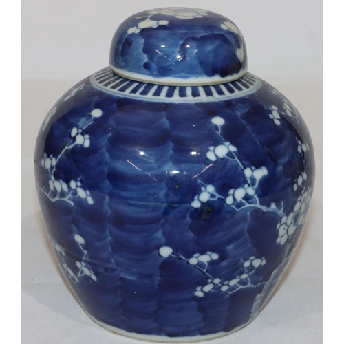 137 - An Oriental blue and white round bulbous shaped lidded ginger jar with blossom and branch decoration... 