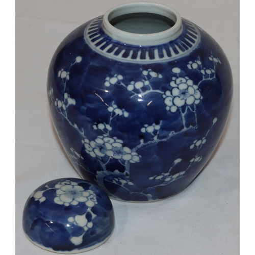 137 - An Oriental blue and white round bulbous shaped lidded ginger jar with blossom and branch decoration... 