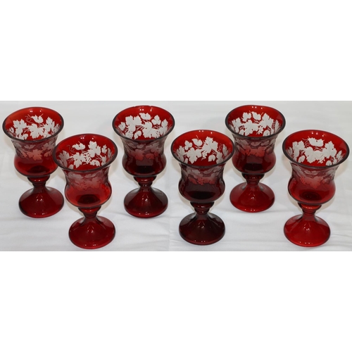 16 - A set of 6 ruby round trumpet shaped wine glasses with engraved grape and vine decoration (1 rim chi... 