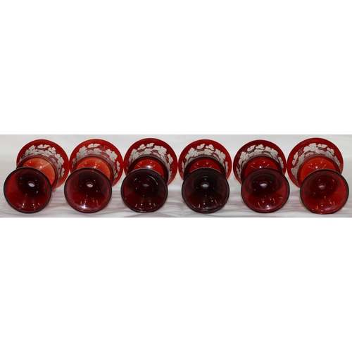 16 - A set of 6 ruby round trumpet shaped wine glasses with engraved grape and vine decoration (1 rim chi... 