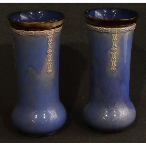 168 - A pair of Royal Doulton glazed earthenware round bulbous thin necked trumpet shaped vases on pale bl... 