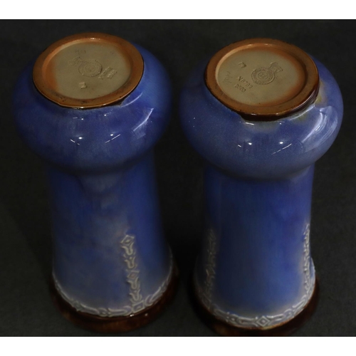 168 - A pair of Royal Doulton glazed earthenware round bulbous thin necked trumpet shaped vases on pale bl... 