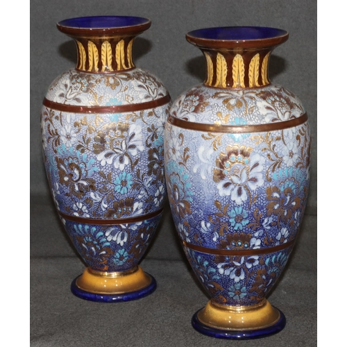 20 - A pair of Royal Doulton glazed earthenware round bulbous thin necked trumpet shaped vases on blue an... 