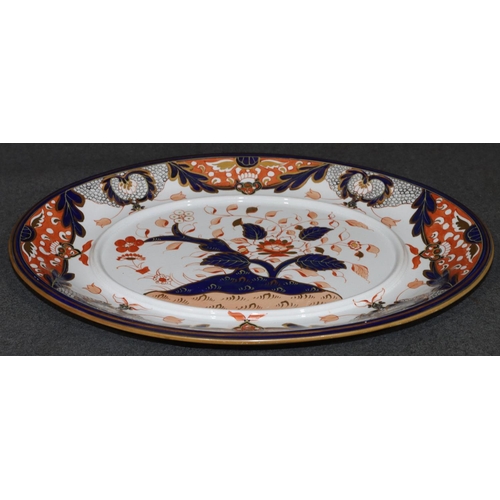 22 - A Crown Derby oval tureen saucer on Imari ground with floral and gilt decoration, 37.5cm wide