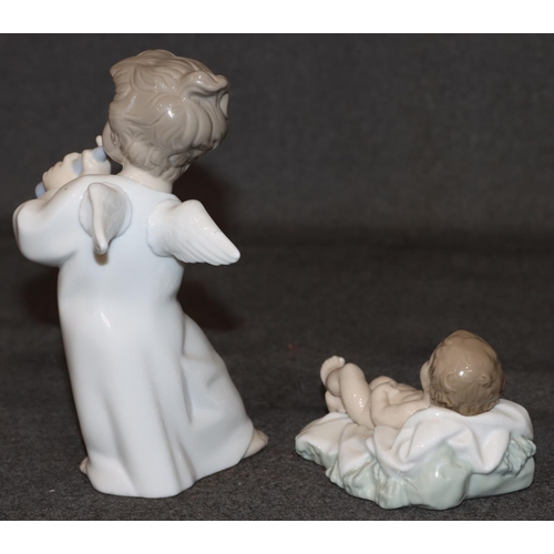 31 - A Lladro figure of a young angel playing a flute, 16.5cm high and a Nao figure of a baby, 10.5cm wid... 