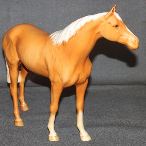 4 - A large Beswick figure of a Palomino horse, 28.5cm high, 36cm long