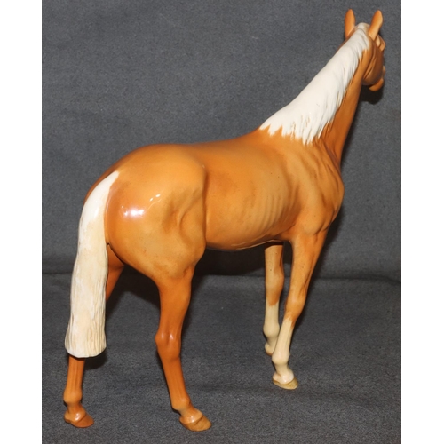 4 - A large Beswick figure of a Palomino horse, 28.5cm high, 36cm long