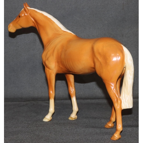 4 - A large Beswick figure of a Palomino horse, 28.5cm high, 36cm long